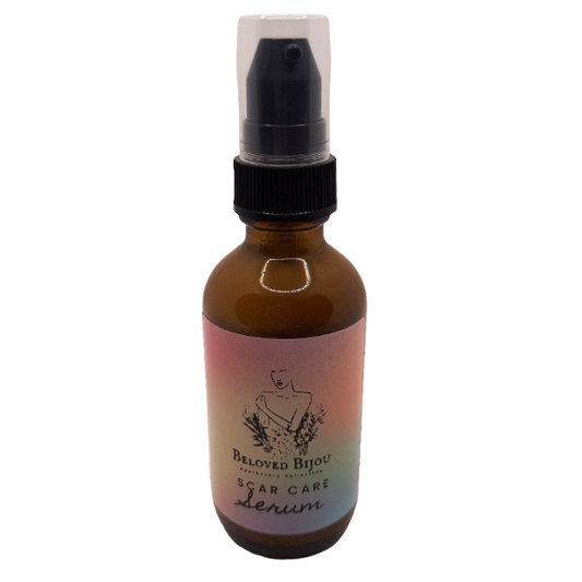 Amber glass bottle with a pump top labeled 'Beloved Bijou Scar Care Serum' on a white background.