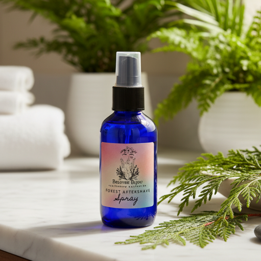 Blue bottle of forest aftershave spray on a marble surface with greenery in the background