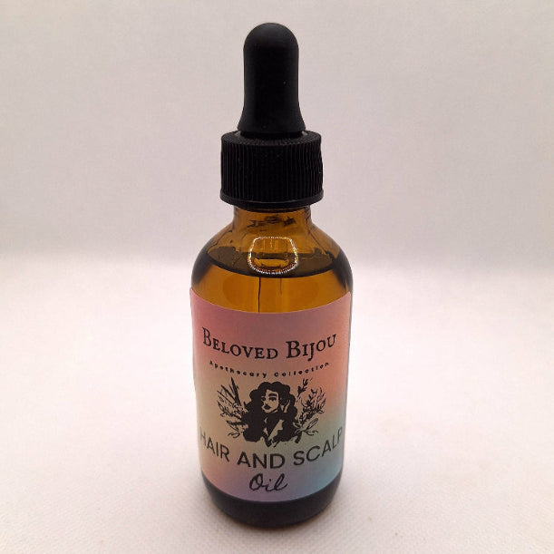 Bottle of 'Beloved Bijou' hair and scalp oil with a dropper on a white background