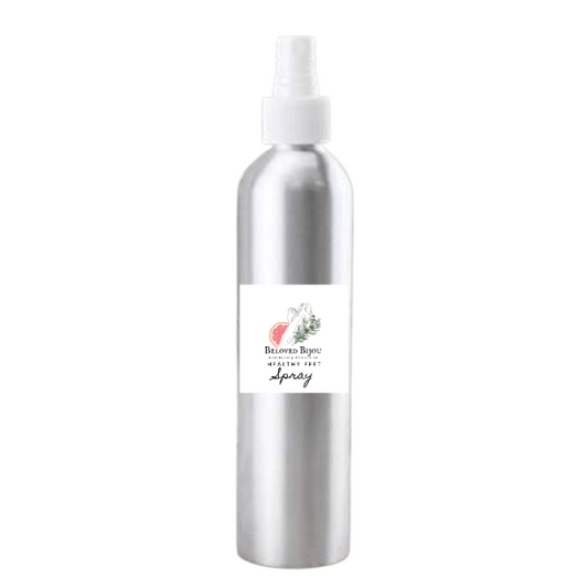 Silver spray bottle with a label on a white background