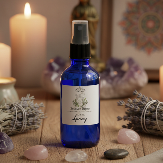 Blue spray bottle labeled 'Limpia Spray' on a wooden surface with candles and crystals in the background.