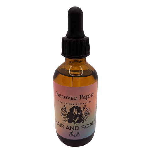 Bottle of Beloved Bijou hair and scalp oil with a dropper on a white background