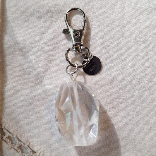 Crystal keychain with metal clasp on a textured fabric background