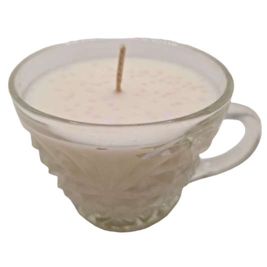 Candle in a glass teacup on a white background