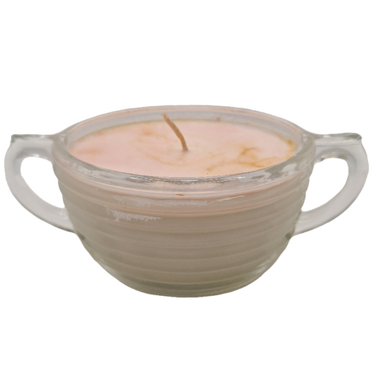 Candle in a glass holder with handles on a white background