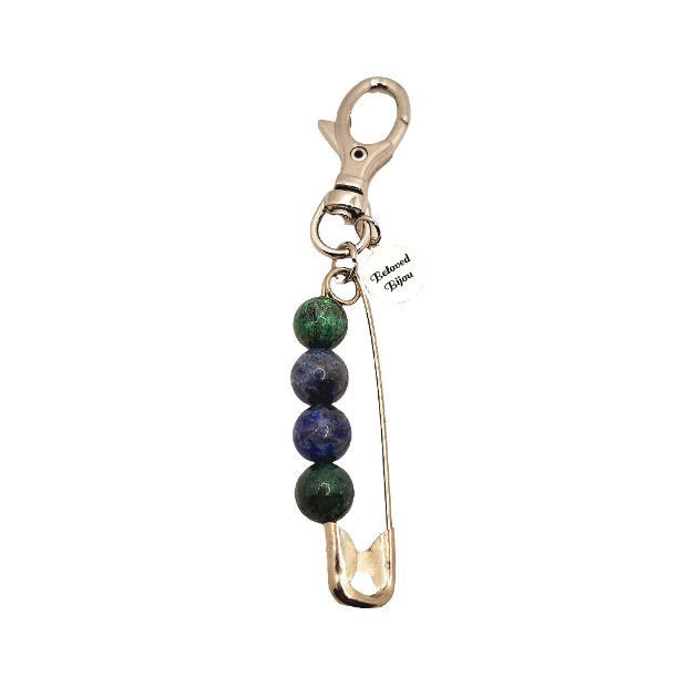 Keychain with safety pin and beads on a white background