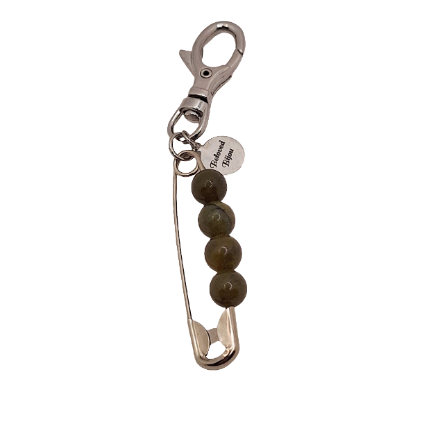 Keychain with safety pin and beads on a white background
