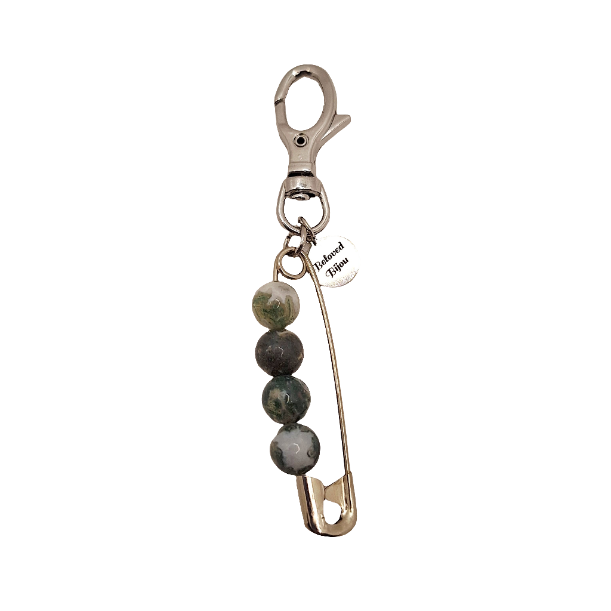 Keychain with safety pin and beads on a white background
