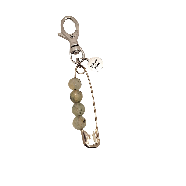 Keychain with safety pin and beads on a white background