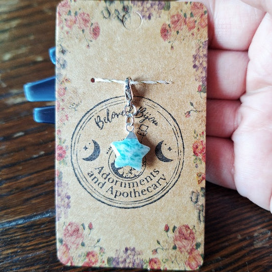 Star-shaped charm on a floral card with 'Beloved Bijou' branding