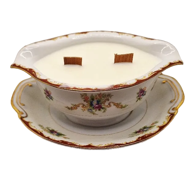 Decorative ceramic gravy boat candle with floral patterns on a white background