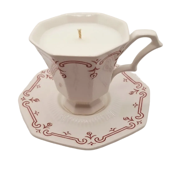 Decorative ceramic cup and saucer with a candle inside on a white background