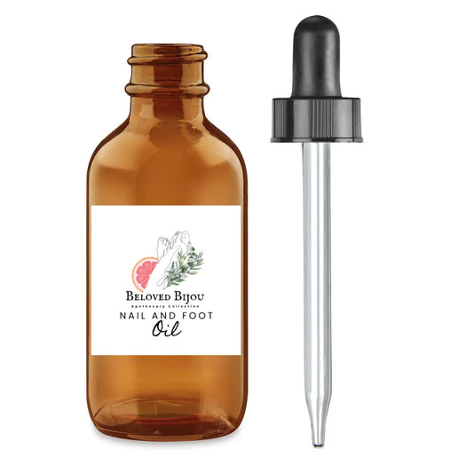 Amber glass bottle with dropper labeled 'Beloved Bijou Nail and Foot Oil' on a white background