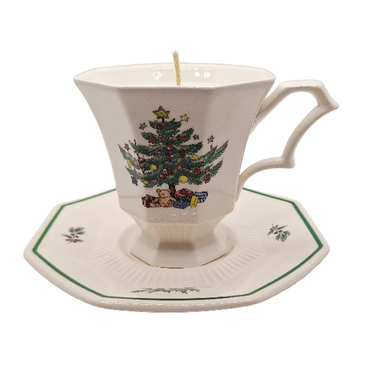 Teacup and saucer with Christmas tree design on a white background