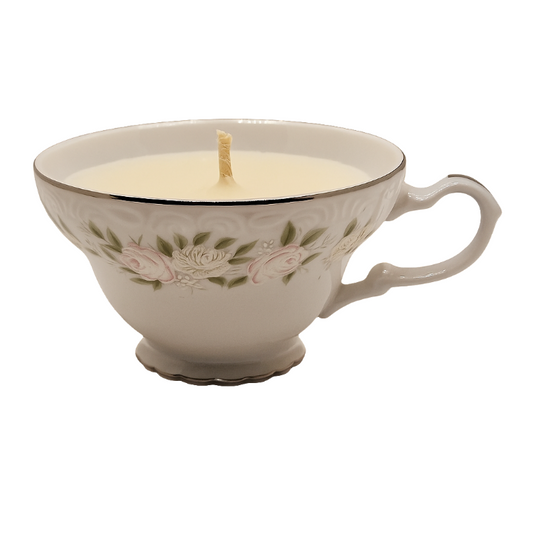 Soy wax Teacup candle with embossed rose design on a white background