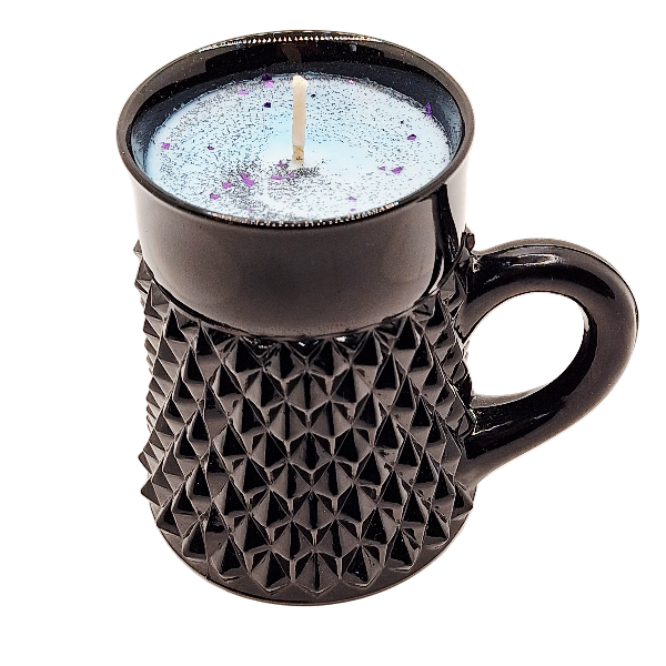 Black textured mug with a candle inside on a white background