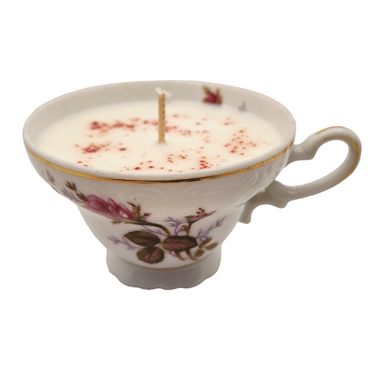 Teacup candle with rose design on a white embossed background