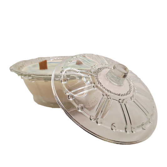 Soy Wax wood wick Candle in a Clear vintage glass container with a lid on a white background