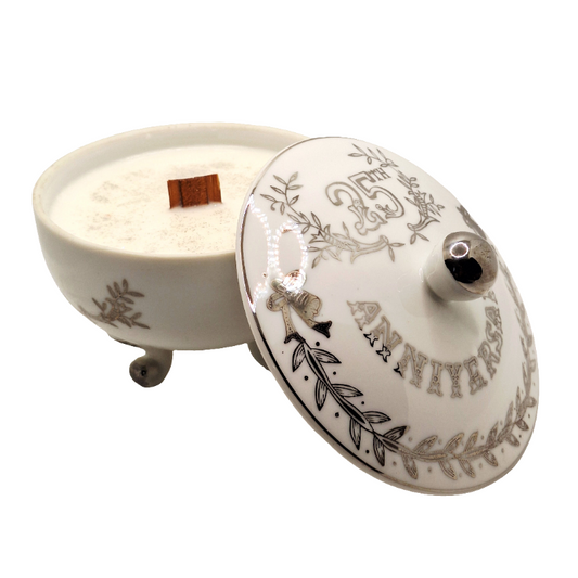 Decorative porcelain container with lid featuring floral designs on a white background