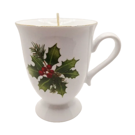 White mug with holly design on a white background