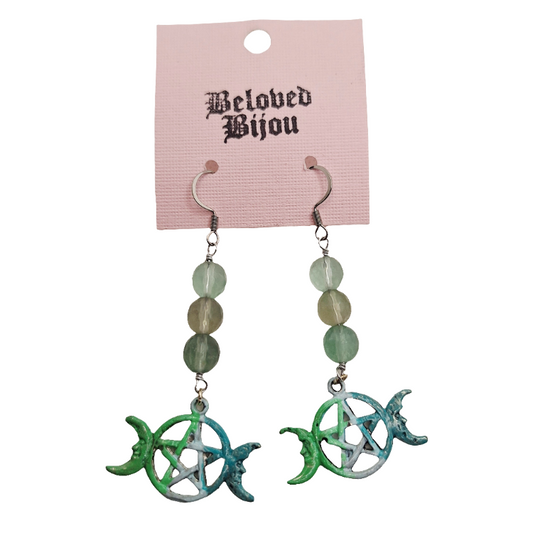 Pair of earrings with green and blue designs on a pink 'Beloved Bijou' card.