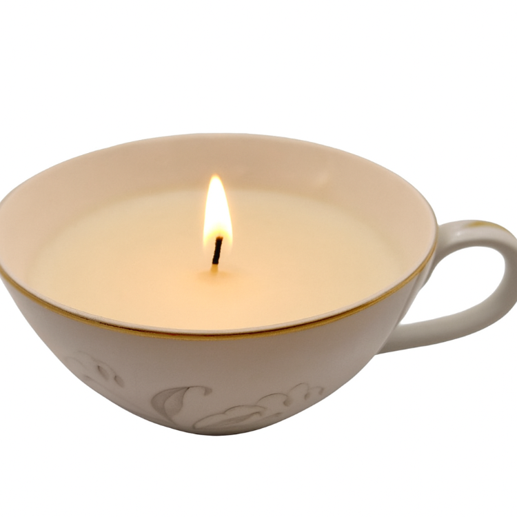 Candle in a white porcelain cup on a white background