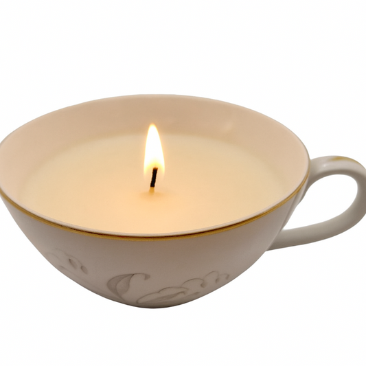 Candle in a white porcelain cup on a white background
