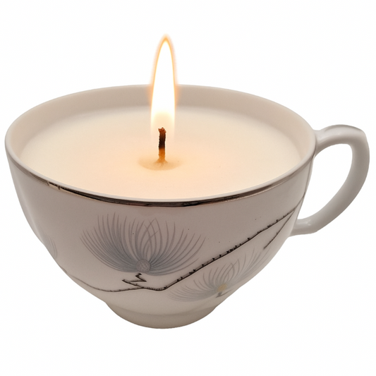 Candle in a teacup with a white background