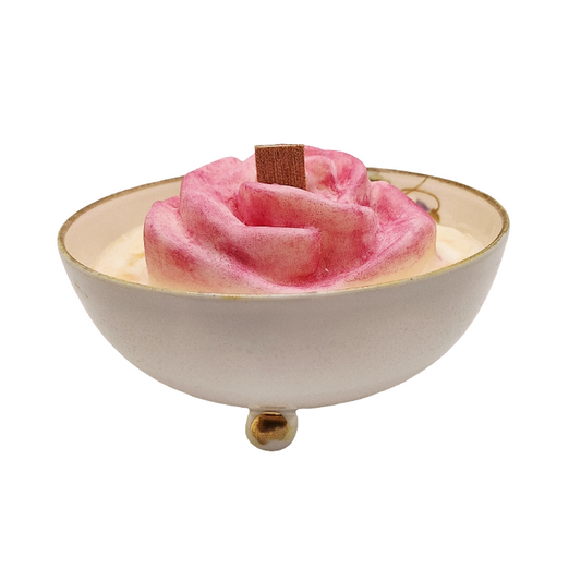 Pink cotton molded rose soy wax wood wick candle in a white Japanese bowl with gold rim on a white background.  Wood wick candle