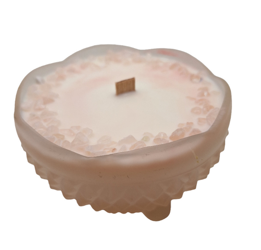 light pink glass wood wick candle with textured surface on a white background